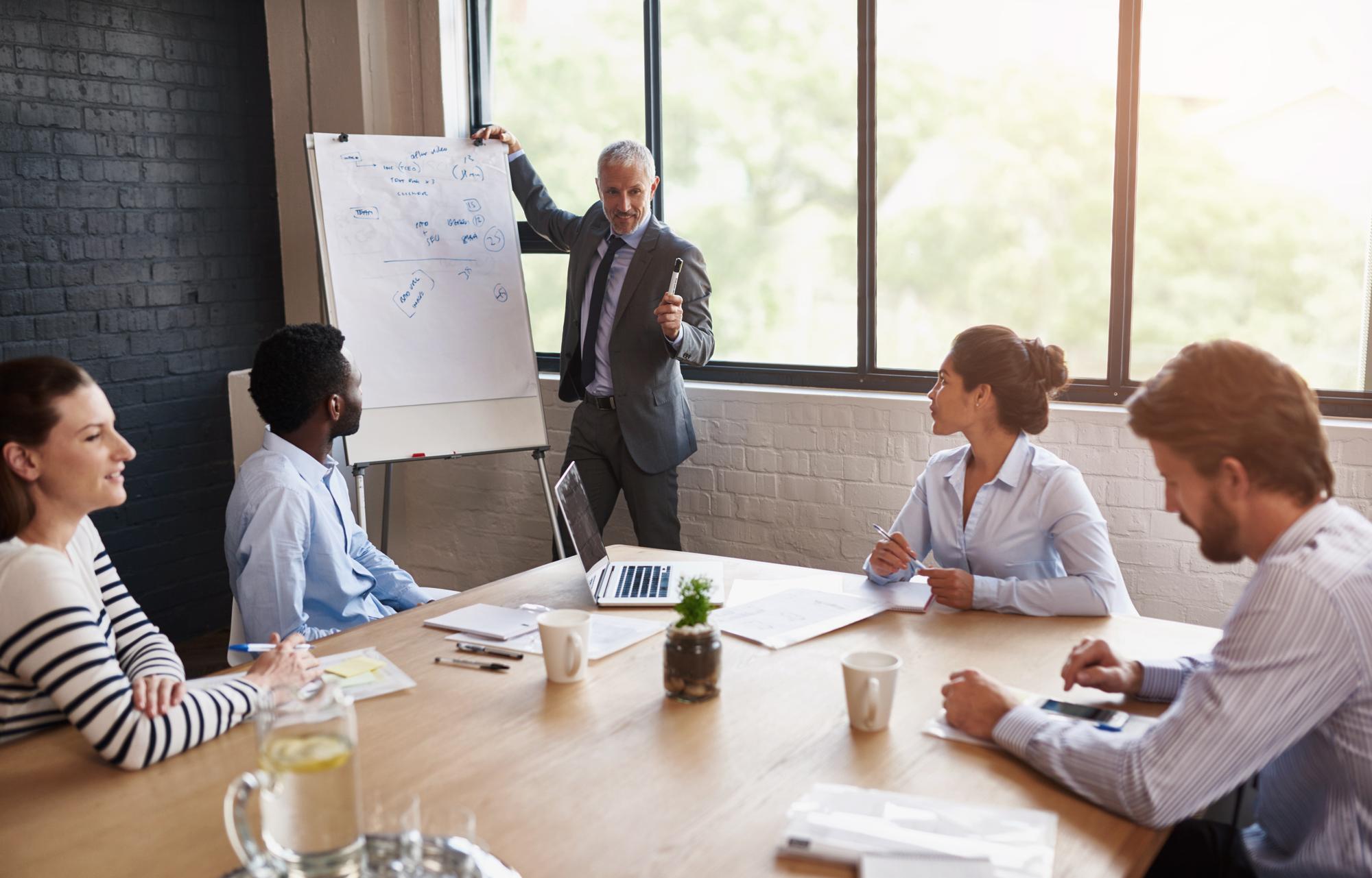 Deal advisory professionals presenting completed acquisition transaction with stakeholder benefits